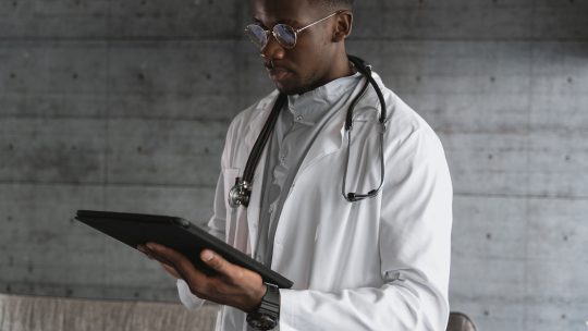 A Doctor Using a Tablet