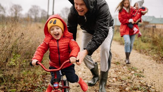 Father Teaching His Son How to Ride a Bike