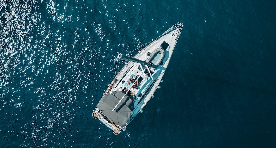 High Angle Photo of White Boat on Body of Water