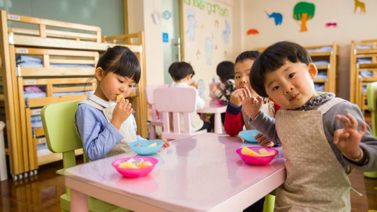 Three Toddler Eating on White Table